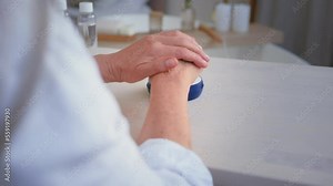 Female beauty procedures health skincare concept. Close up unrecognizable old senior mature middle-aged wrinkled woman rubbing hands applying natural hand cream skin sensual moisturizing rejuvenation