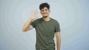 Happy man waving at camera.