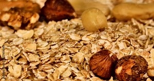 Extreme close up video of spelled flakes with other breakfast cereals and nuts on a turning plate.