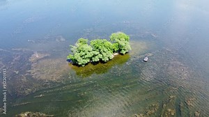 Pewaukee Lake In Waukesha County, Wisconsin; Aerial Drone Tilt Up From A Small Islet To The Main Village And Lakefront Park.