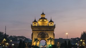 Vientiane Laos time lapse 4K, city skyline day to night sunset timelapse at Patuxai (Patuxay)