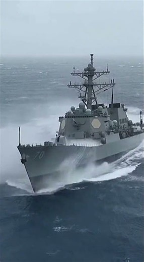 Powerful Warship Navigating Through Stormy Seas 🌊
