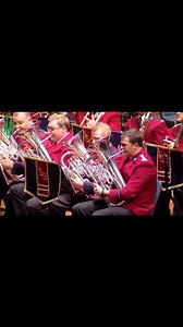 5.7K views · 55 reactions | Enjoy this captivating performance by a talented concert band, clad in striking red jackets, delivering a symphony of winds, brass, and percussion on a grand stage adorned with historical emblems and flags. A true celebration of musical heritage! #ConcertBand #LiveMusic #ClassicalPerformance #BandMusic #CulturalEvent #OrchestraVibes Video credit to the rightful owner. | Marching Melodies | Facebook