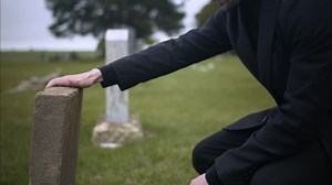 Premium stock video - Sad, emotional man in cemetery grieving over death of loved one