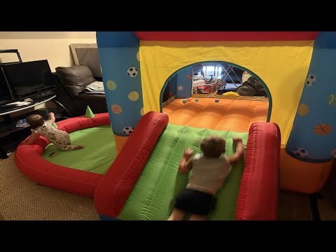 Inflatable bounce house with a 2 and 1 year old