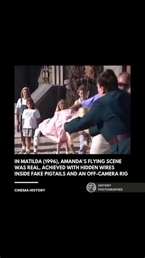 In the 1996 film Matilda, the scene where Miss Trunchbull throws Amanda Thripp by her hair was filmed using a specialized harness and wires hidden inside reinforced pigtails. The young actress actually swung through the air on a crane-like rig to achieve the effect, though she wore a safety suit and landed safely on padded mats. Credit: Sony Pictures Entertainment | History In Pictures