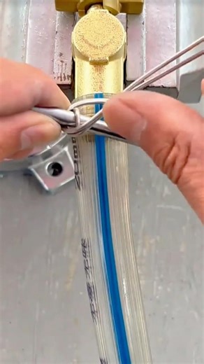 Carefully Securing a Metal Wire Around a Pipe Connector for a Strong and Precise Installation