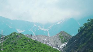 Beas River flowing as waterfall in mountains near its origin Beas Kund in Himachal Pradesh, India. Dark monsoon clouds over Himalaya mountains. Nature landscape