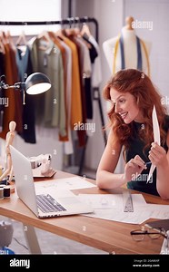 Female Business Owner Working In Fashion Showing Designs On Video Call Using Laptop Stock Photo - Alamy