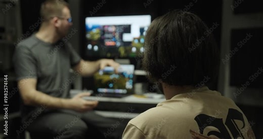 Man explaining software or a website on a computer screen to a colleague. Concept of teamwork, IT support and workplace communication.