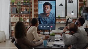 Workmates with Face Mask Talking on Video Conference Call to Man