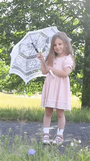 clip-4016888711-little-girl-holding-white-crochet-umbrella-looking