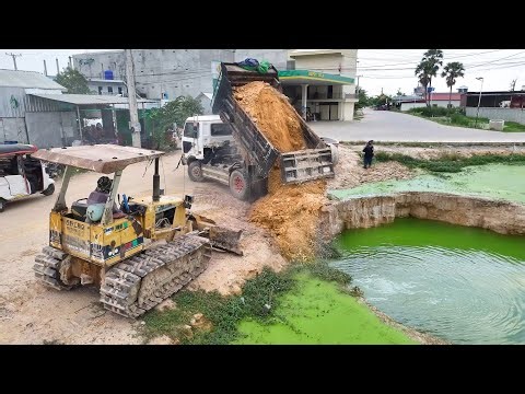 Start a new project with a Mini Dozer Komatsu D20p, pouring soil into fields and ponds