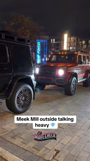 Meek Mill outside talking heavy