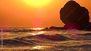 Waves of the Sea of Azov roll onto the shore at sunset, General's beaches, Crimea, Russia.