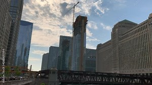 Cityscape view of el tracks and Wacker Drive as commuters head home at the end of a spring day.