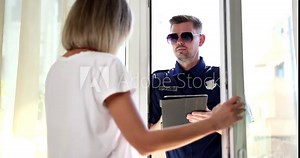 Police officer interviews victims after breaking into private home