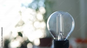 Blurred Shooting with a Person Powering Off the Led Light Bulb in a Room Using Smartphone App. Low Energy Consumption Concept with Led Lighting Technology. Powering Off the Light in a Room.