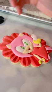 Adding final details to these Amy Rose cookies! . All painted details are made with @americolor gels mixed with a tiny bit of water. 😊 . . . #sugarcookies #twinklestartreats #sonicthehedgehog #soniccookies #amyrose | Twinkle Star Treats