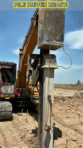 Excavator Mounted Vibratory Pile Driver in Action - Powerful Concrete Pile Driving Technology.