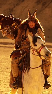 A young man from the #Daur ethnic group is showing his colorful ethnic culture, full of vibrant and confidence. The Daur ethnic group lives in the northeastern province of #Heilongjiang. They see the raptor as part of their totem worship, showing their awe and respect for #nature. | T-Time HK