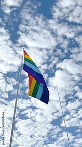 Cusco Flag Waving, Peru. Inka Rainbow flag of Cusco Peru blows in the wind on a blue sky day. Tahuantinsuyo flag
