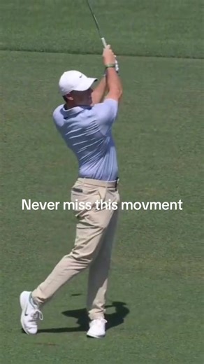 The video begins with a close-up of the golfer’s arm and stance, building anticipation. You can tell he’s focused and preparing for a precision shot. Then it cuts to a wide-angle view where the golfer takes a powerful swing on a beautiful green golf course. The environment looks like a professional tournament setting, with a crowd watching quietly on the sides. As the club hits the ball, the shot transitions into a ball-tracking view. You see the golf ball flying high into the sky, which shows: