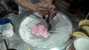 Making ice cream rolls on cold plate