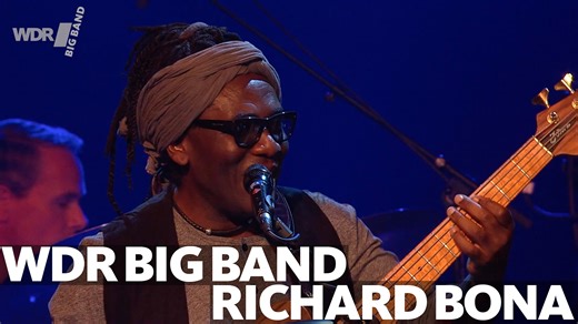 The tropical heat continues here in Cologne and we'll provida a suitable sound track to go with it. "Manyaka O Brazil" is a composition by bass player extraordinaire Richard Bona, here in an arrangement by Vince Mendoza. Besides Richard himself it also features John Marshall on flugelhorn and Shannon Barnett on trombone. Recorded in 2016 at the Leverkusener Jazztage, conducted by Vince mendoza. Make sure to drink plenty of water today! ------------------- Die tropische Hitze hält hier in Köln an