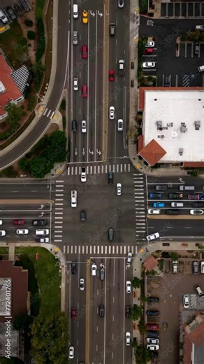 Hyperlapse aerial vertical footage of vehicles and cars driving on a crossroads in the city