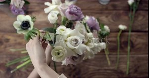 Young Florist Assembles a Rustic Wedding Bouquet. Young florist assembles a perfect wedding bouquet. Her flowers are wonderful, the colors are so rustic, she has perfect taste.