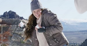People in the snow, snowball fight and playful together outdoor, winter season and Christmas holiday in cold weather. Happy, excited and friends in nature, celebration or vacation for December break