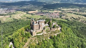 Burg Hohenzollern castle between Hechingen and Bisingen Germany, was the medieval castle of the Hohenzollern family. Stronghold fortress culturale heritage. Aerial drone overhead view in summer.