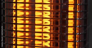 Heating device with red-hot spiral filament. Infrared heater. Energy efficient space heater. Vertical freestanding infrared heater for indoor use. Cinema 4K 60fps tilt view video Stock Video