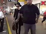 Amber heard returns to LA with beefy bodyguard on her arm