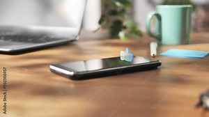 smartphone on the table showing 3d like icon graphic animation on the phone screen