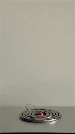 iGuzzini PizzaKobra Lamp ​Designed by Ron Arad, this table lamp features a flexible concentric spiral that expands and retracts. It is equipped with an adjustable head, touch switch, and standby sensor, all crafted from chrome-plated stainless steel and aluminum. | GIGadgets