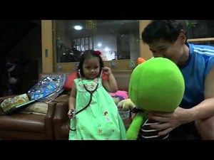 Two year old play with a stethoscope and medical thermometer