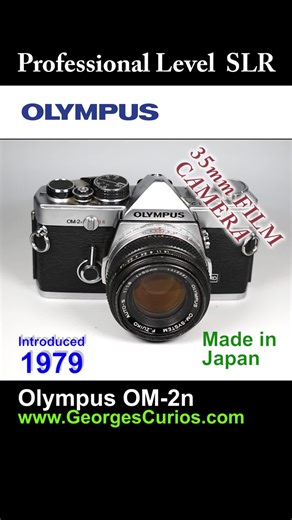 1979 Olympus OM-2n - 35mm Film Camera Vintage Film & Digital Cameras & Accessories for Sale in UK: https://georgescurios.com/ Produced from 1972, the OM System cameras came in 2 ranges, the High End Pro ‘single digit’ OM-1 / 2 / 3 & 4 and the Mid-Range Consumer ‘two digit’ OM-10 / 20 / 30, etc, models. All use the OM Mount lenses. So, the OM-2n is a professional level SLR camera introduced in 1979, an update on the OM-2 of 1975. It is the automatic version of the OM-1. It has an electronic shutt