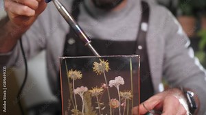 floral design. Man with his hands to make a beautiful flower arrangement, the concept of flower design, ikebana. Dried flowers composition, craftsman making decoration for home