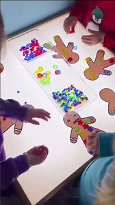Gingerbread fun at the light table! Preschoolers are decorating blank gingerbread cookie shapes