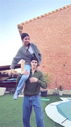 Boy's Head Gets Stuck in Girl's Sweater While Lifting Her