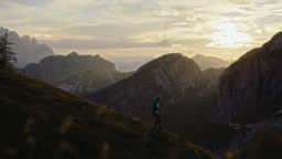 Woman Running on the Slope of Mangart Mountain Showcases the Beauty...