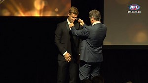 Hawthorn great and (now West Coast Eagle) Sam Mitchell is presented with the 2012 Brownlow Medal moments ago by former teammate and fellow medallist Shane Crawford. Live: afl.to/2hmLzH5 | AFL