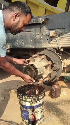 Professional Mechanic Extracting Massive Drive Axle From Rear Hub