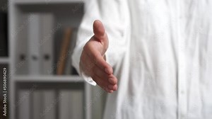 Handshake girl gives a hand. Close-up hand of a man holding out his hand with the aim of getting acquainted. Completion of the deal people handshake successful deal compromise for two people