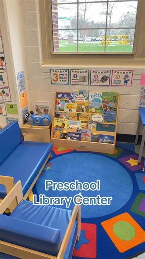 Take a tour of our preschool library center! It's a cozy corner where little learners can dive into the world of books. Our setup includes a variety of picture books, a book on CD, and comfy seating areas perfect for storytime. Discover how we organize our books to encourage independence and a love of reading in our youngest students. | Preschool Vibes