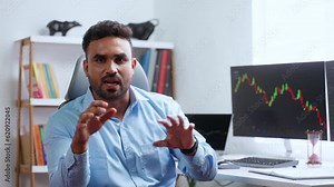 Confident indian trader or stock broker explaining about stock market by looking camera at office - concept of Investment Strategies, trading tips and financial Expert