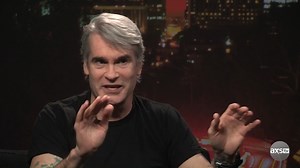 Henry Rollins talks with Tom Green about why he stopped performing and making music. | AXS TV