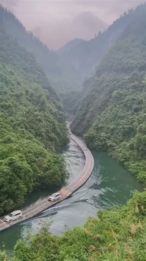 MODERN ARCHITECT on Instagram: "Glide across the water on the Shiziguan Floating Bridge in Hubei, China. 🌊🚗 Known as the ‘Long Bridge of Dreams,’ this 500-meter wooden bridge spans the turquoise Qingjiang River, offering a surreal sensation of driving or walking on water. With lush green forests on both sides, it’s a breathtaking blend of engineering and nature. Would you dare to cross it? 🌿🌉 #China #ModernArchitect"